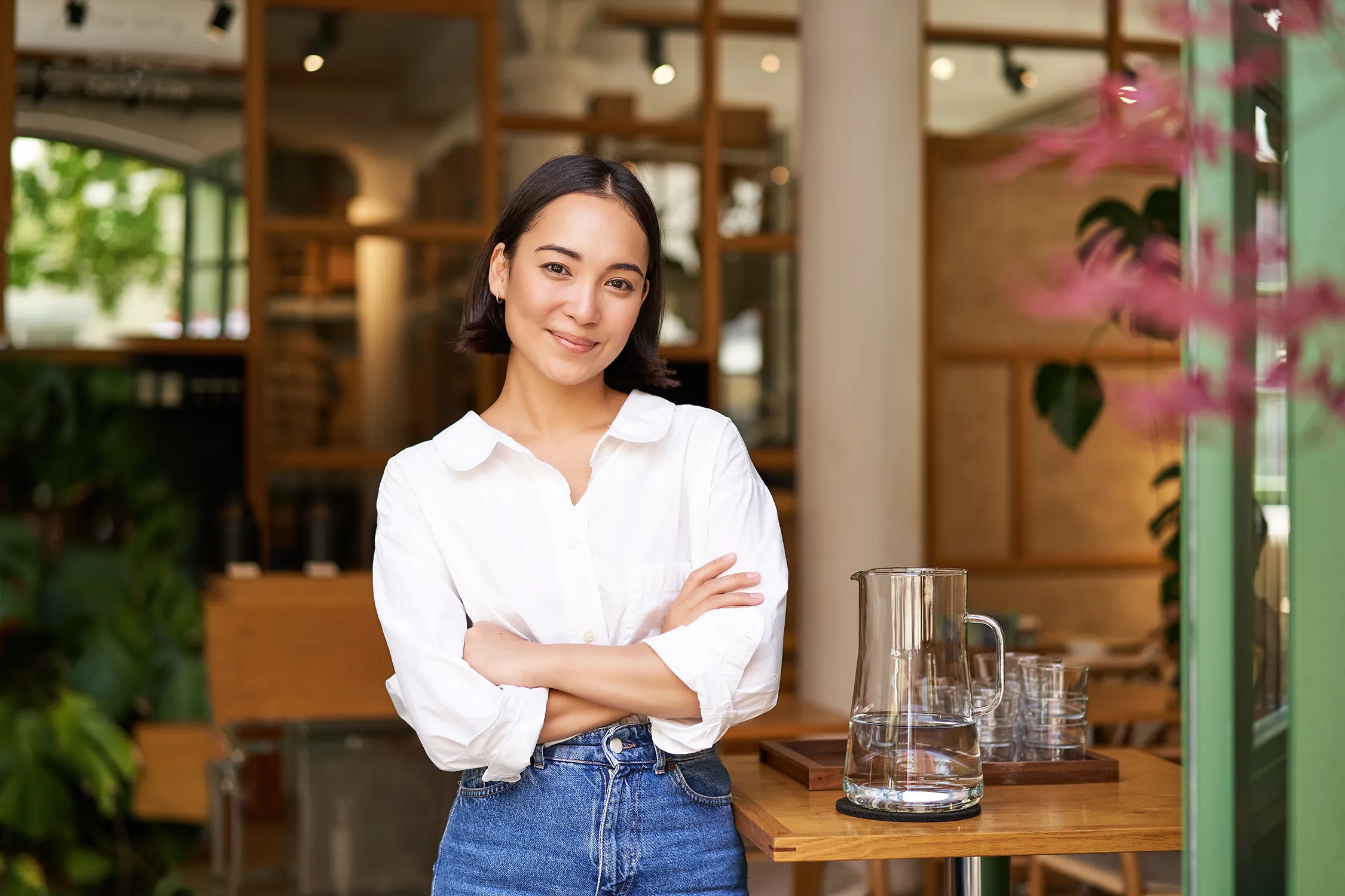 Business owner standing in a cafe workspace with a confident expression